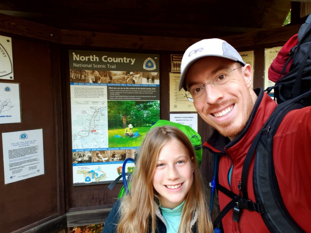 Manistee River Trail sign picture with dad and daughter