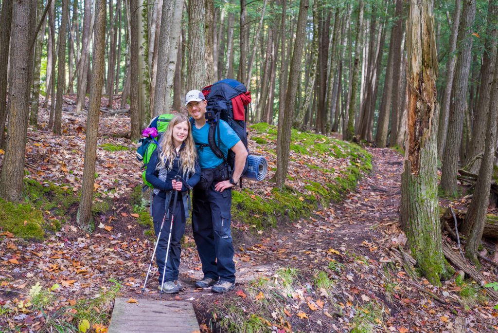 Dad and daughter hiking together on the trail